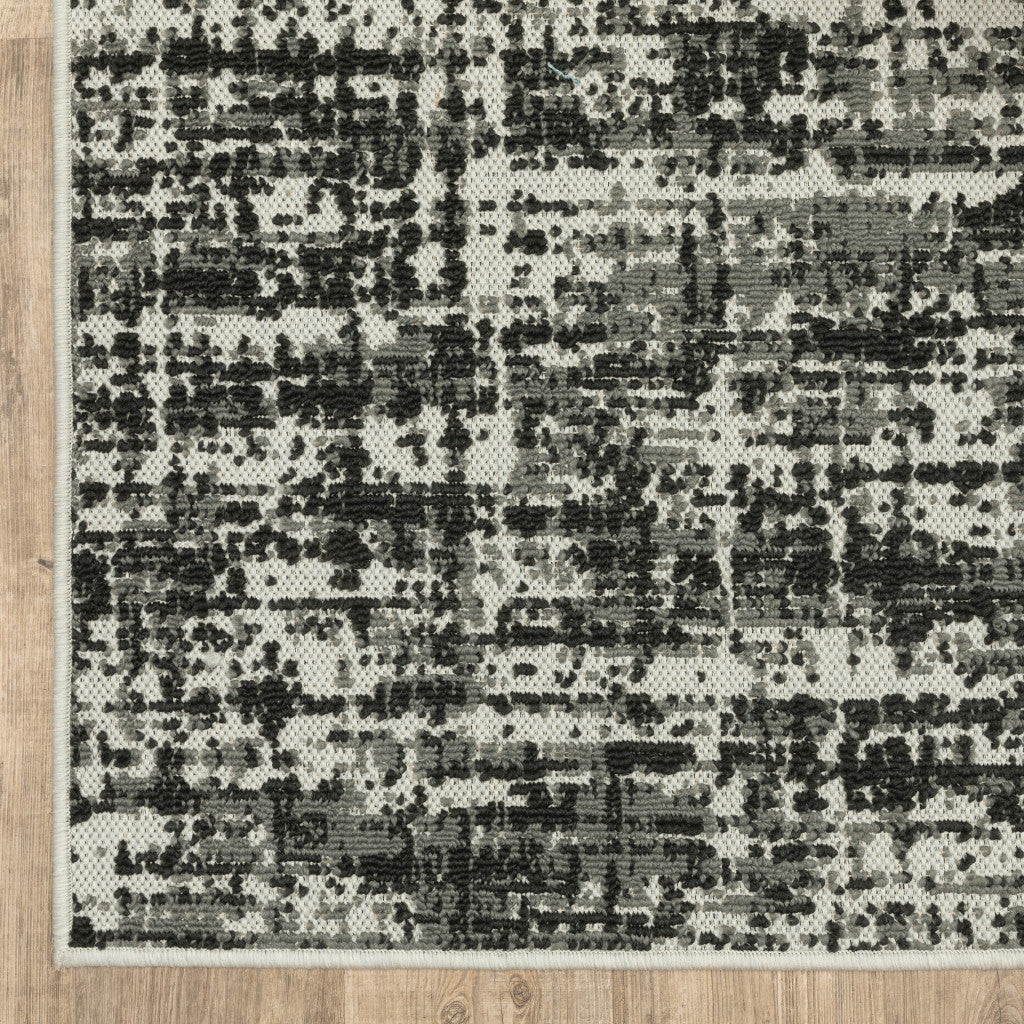 5' X 7' Beige and Black Abstract Stain Resistant Indoor Outdoor Area Rug