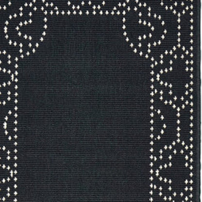 2' X 8' Black and Ivory Stain Resistant Indoor Outdoor Area Rug