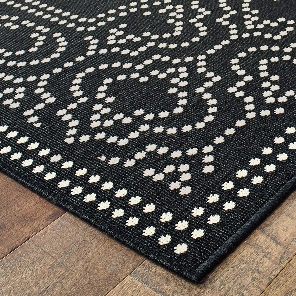 4' X 6' Black and Ivory Stain Resistant Indoor Outdoor Area Rug