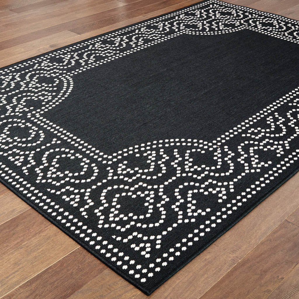 5' X 8' Black and Ivory Stain Resistant Indoor Outdoor Area Rug